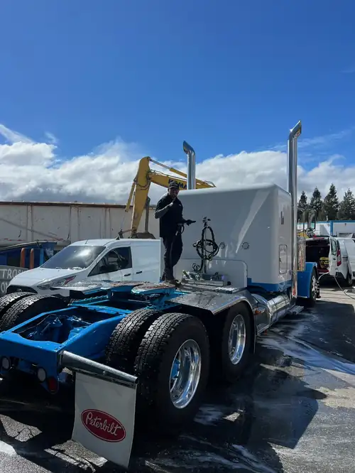 Highline Auto Care washing a white and blue Peterbilt sleeper in a San Jose yard